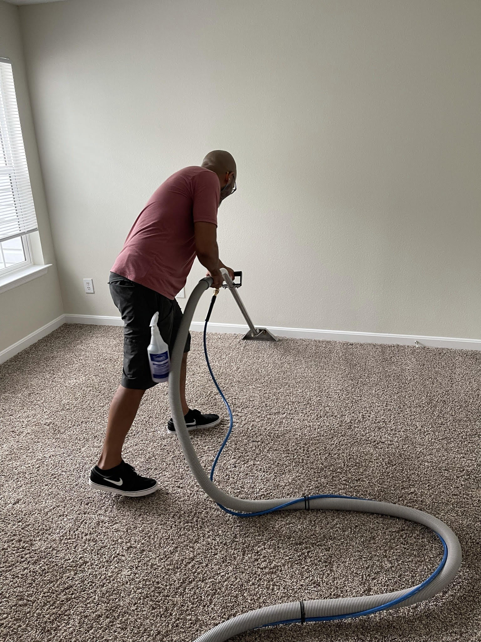 technician carpet cleaning a carpet