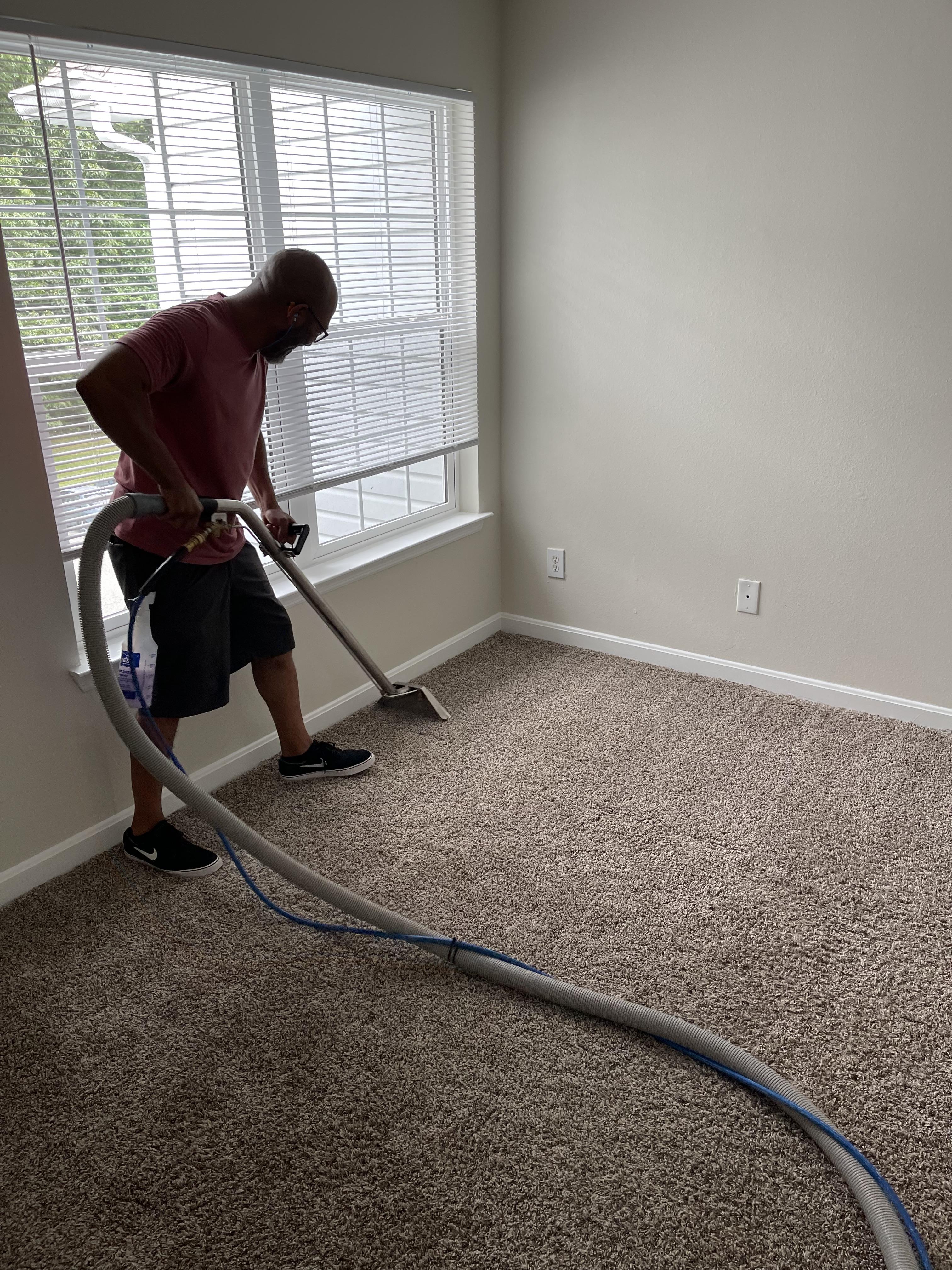 man steam cleaning carpet