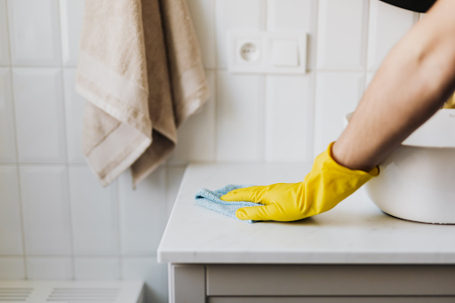 cleaner wiping down bathroom sink