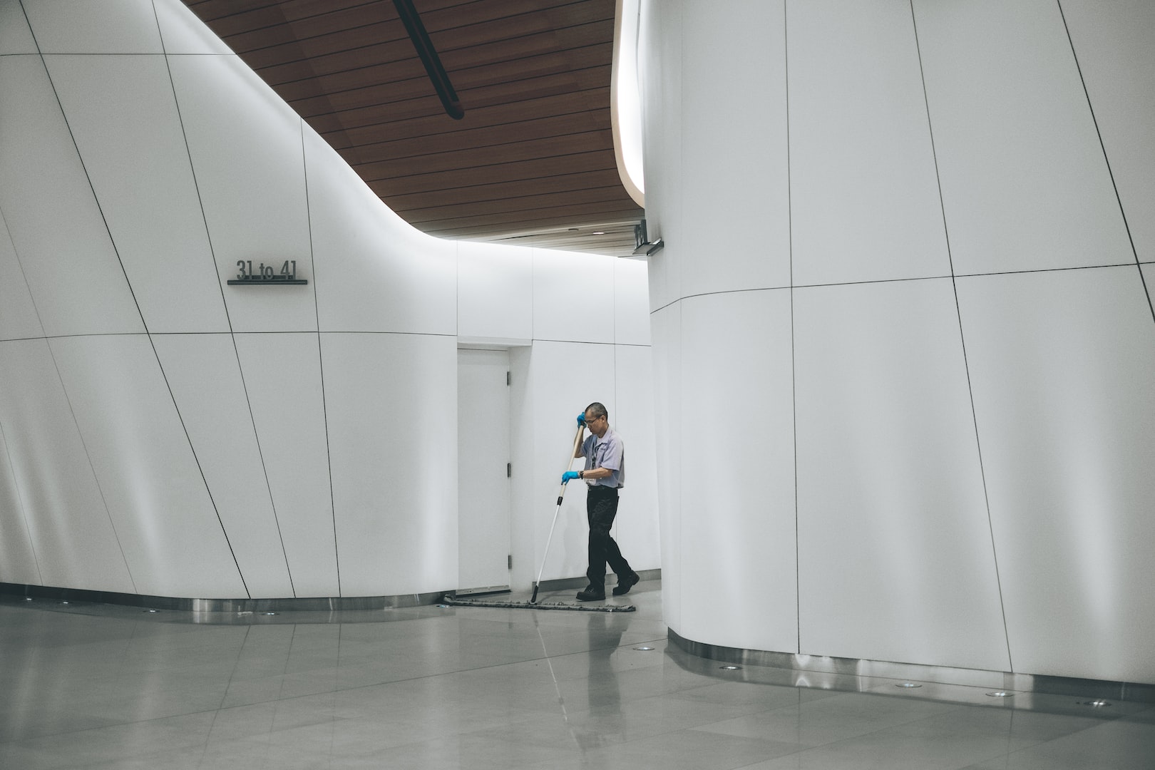 man dry mopping floor in a commercial space