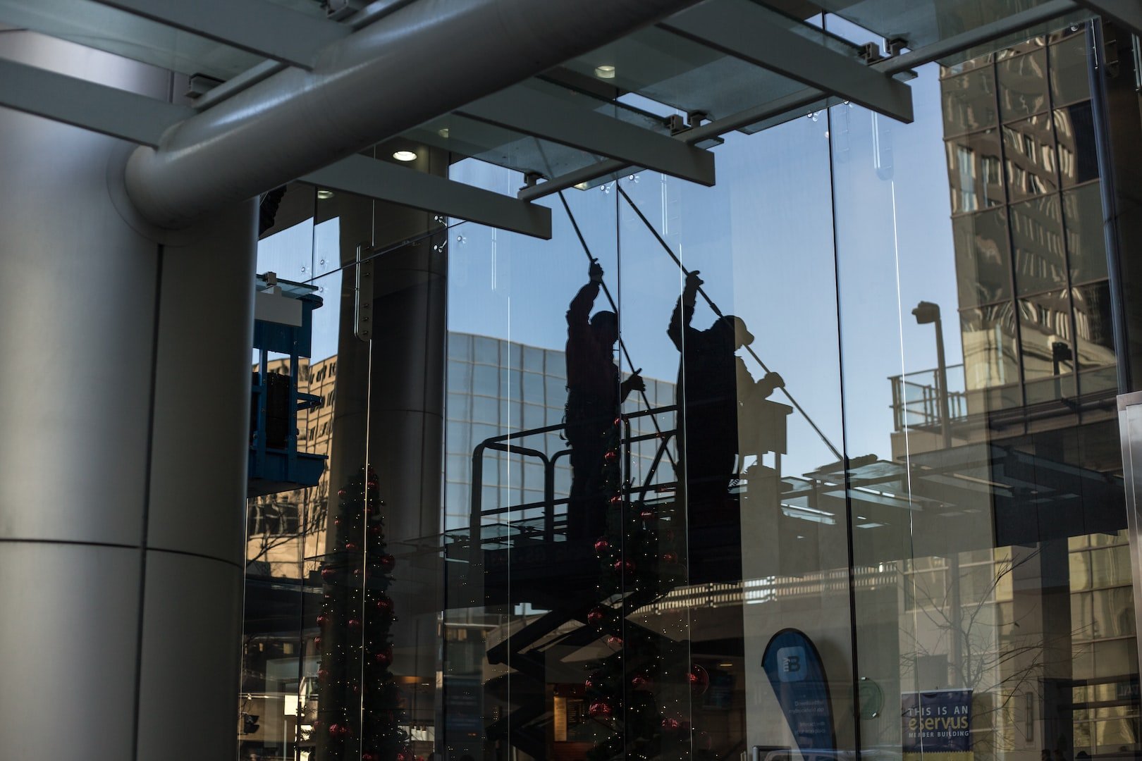 man washing windows on a commercial building