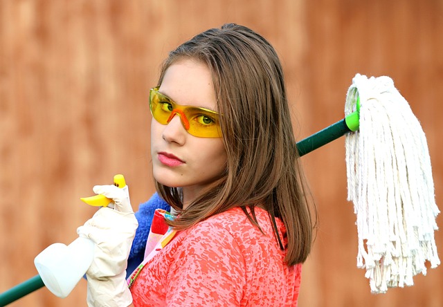 woman holding cleaning tools