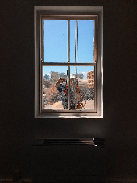 man washing window